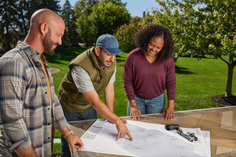 worker showing man and woman bluprints