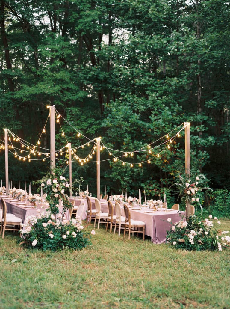 String lights over table and chairs on grass